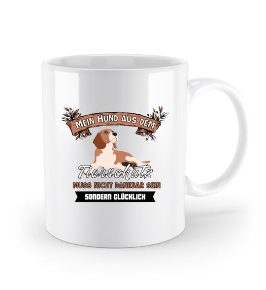 Keramik-Tasse (330 ml) mit dem Spruch Mein Hund aus dem Tierschutz muss nicht dankbar, sondern glücklich sein. Motiv auf einer Seite, Henkel rechts.